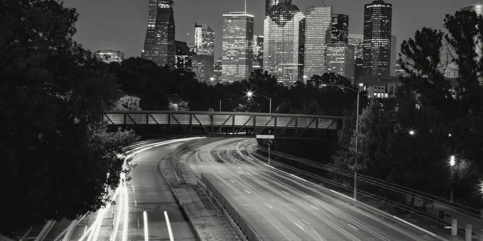 Freeway light trails leading into downtown Houston at night