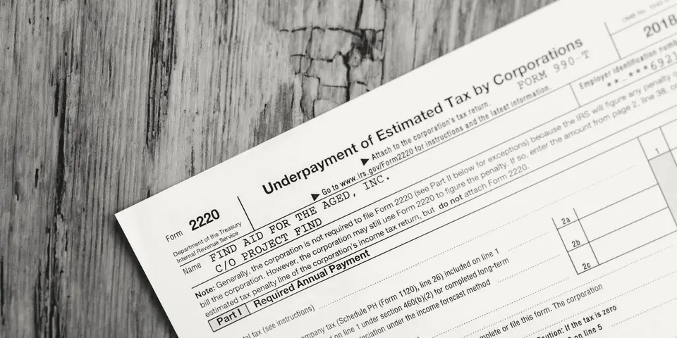 An IRS tax form on a wooden desk